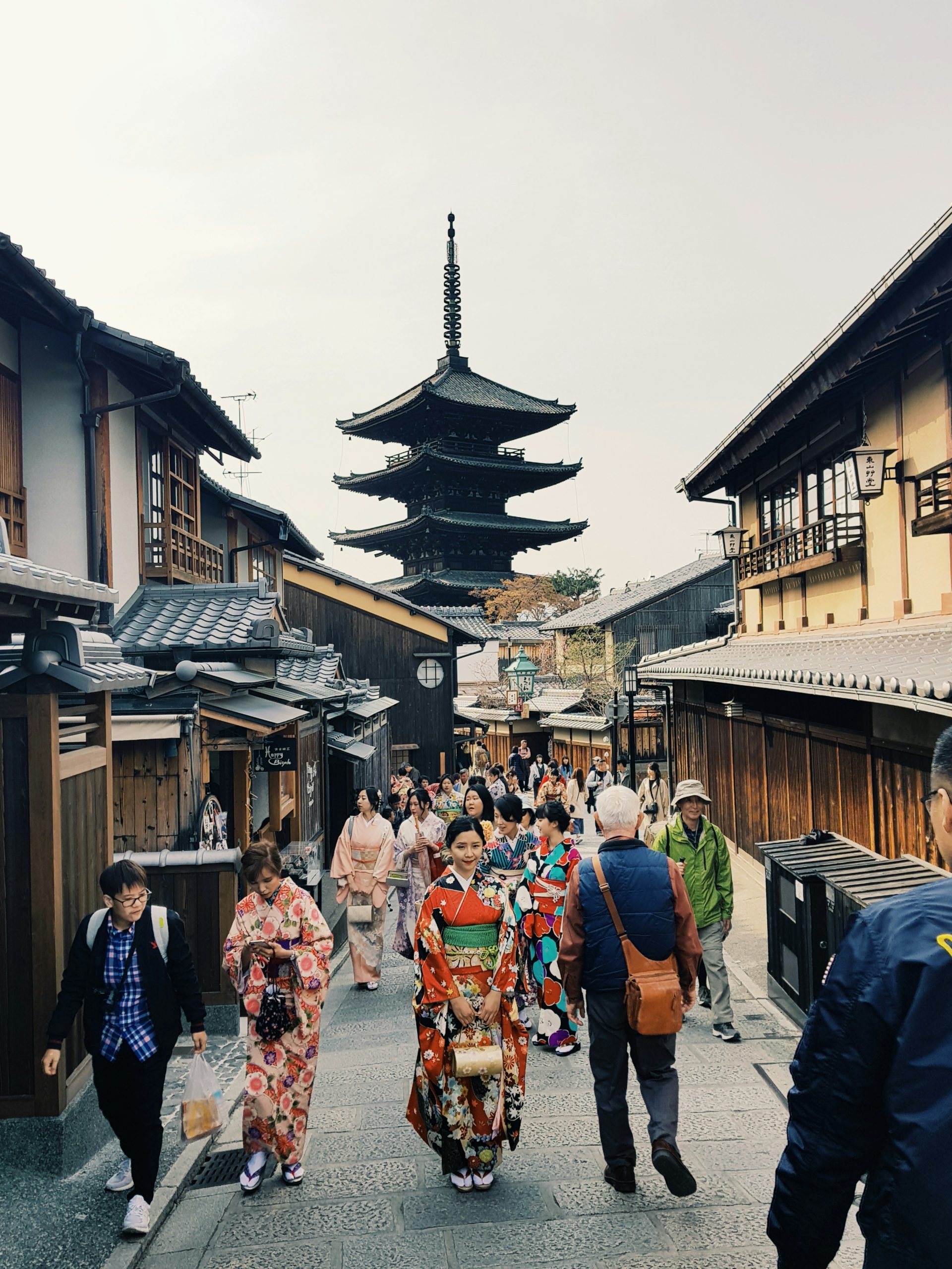 Spectacular fireworks display over Kyoto's famous Kamo River with people in summer kimono enjoying the festival atmosphere