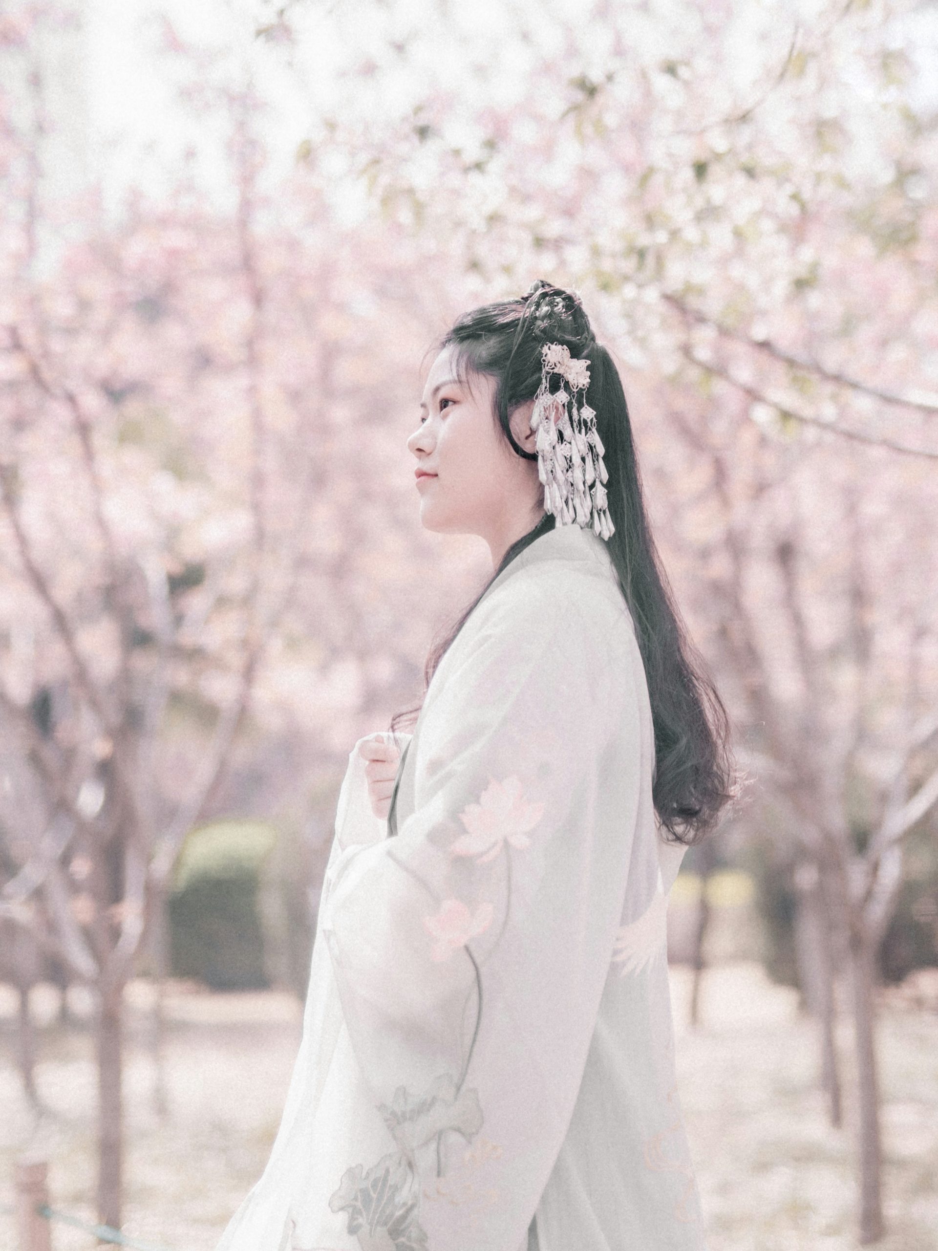 Young woman in traditional Japanese kimono with decorative umbrella posing at Yasaka Pagoda Hokan-ji Temple in Kyoto for professional photography