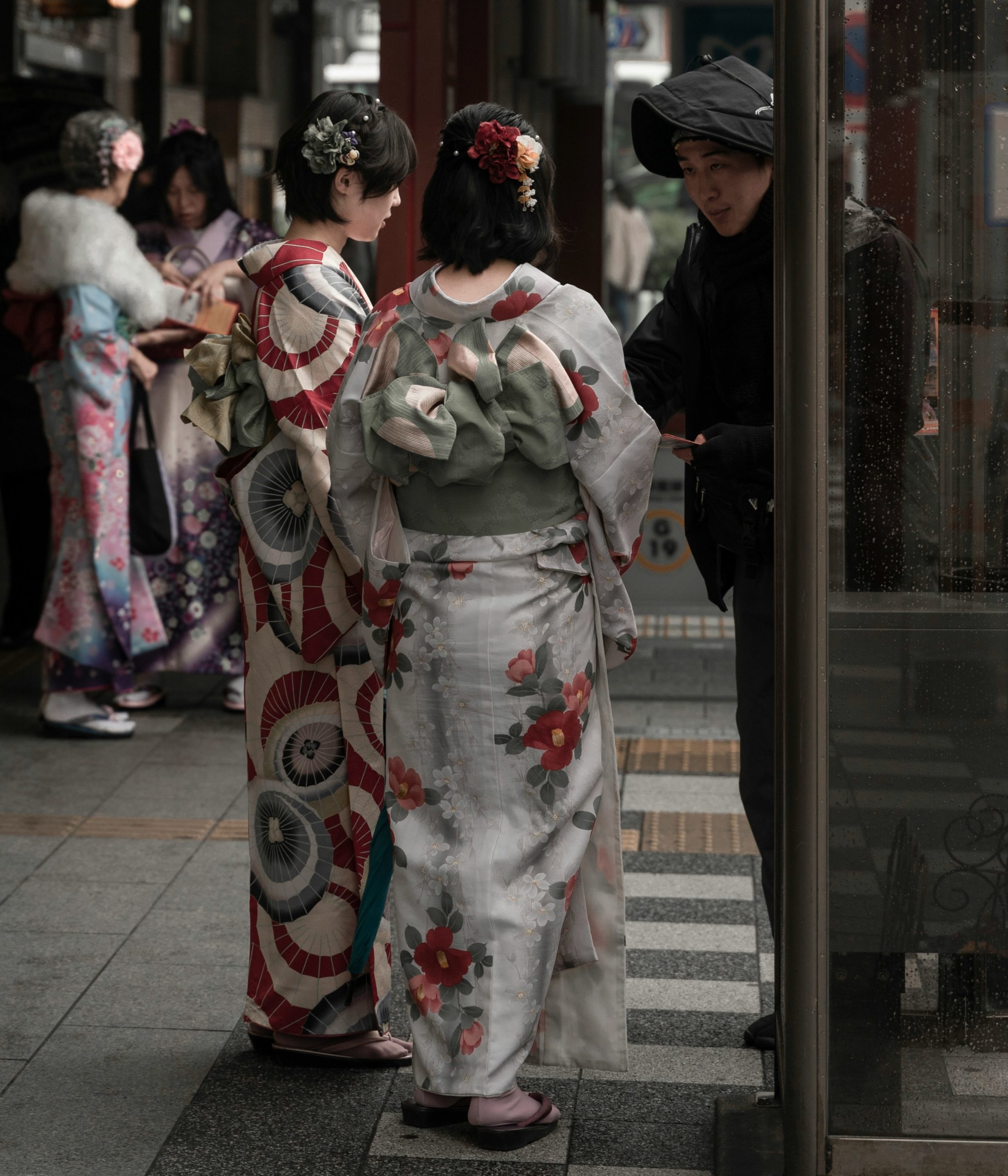 Peaceful bamboo forest pathway with wooden walkway over water feature creating natural covered area perfect for rainy day kimono photography in Kyoto