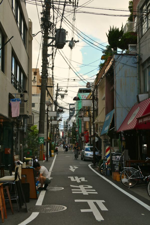 Hanamikoji Street in Gion district at night with traditional lanterns illuminating wooden buildings and creating atmospheric evening scene