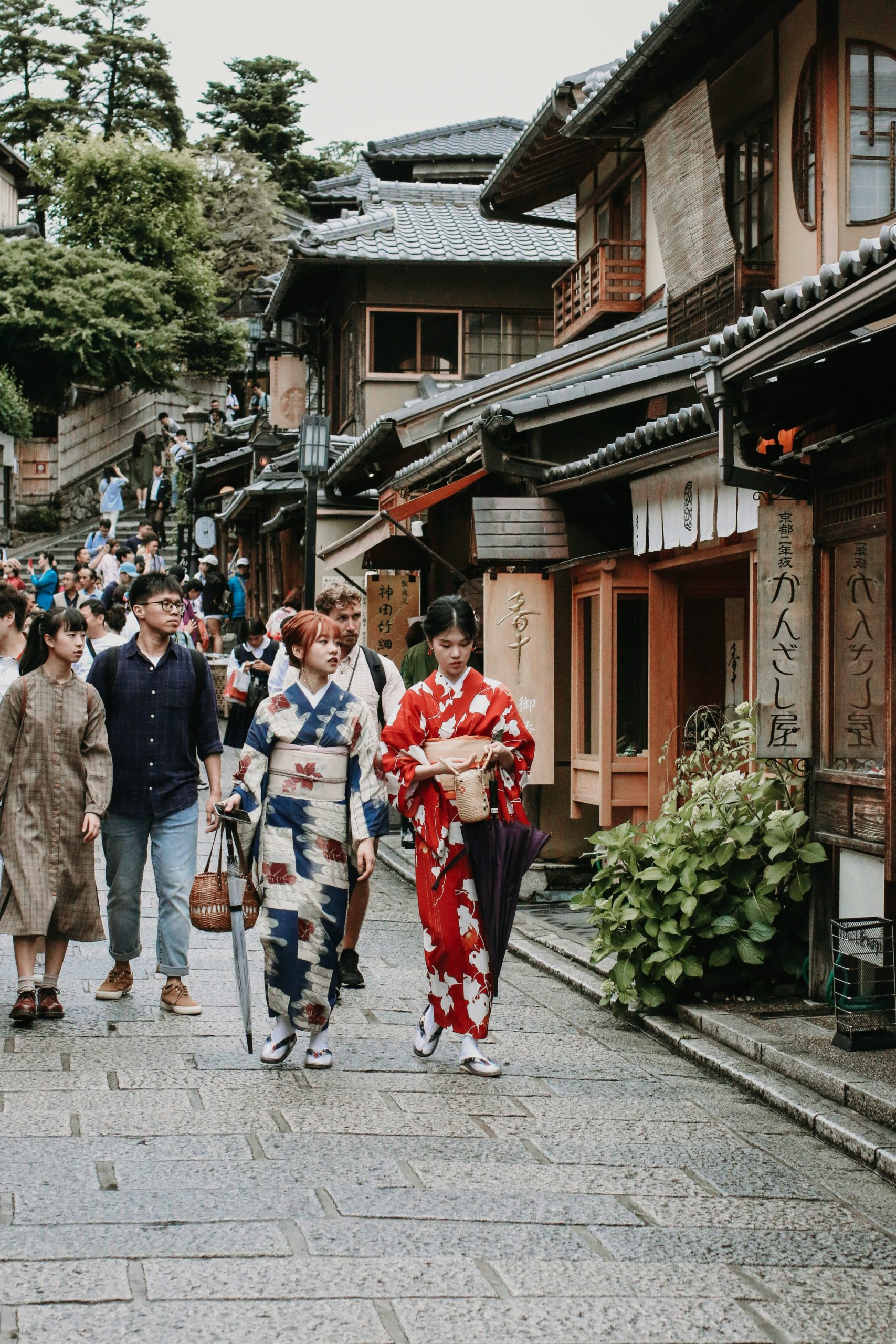 Historic cobblestone streets of Gion district in Kyoto with traditional wooden machiya houses and preserved Japanese architecture