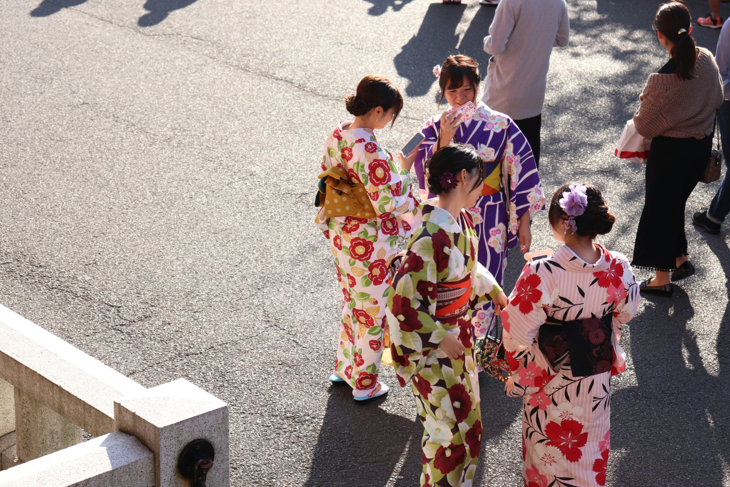 Young adults in colorful furisode kimono celebrating Seijin no Hi Coming of Age Day ceremony in Japan, showcasing traditional Japanese cultural attire and festive atmosphere