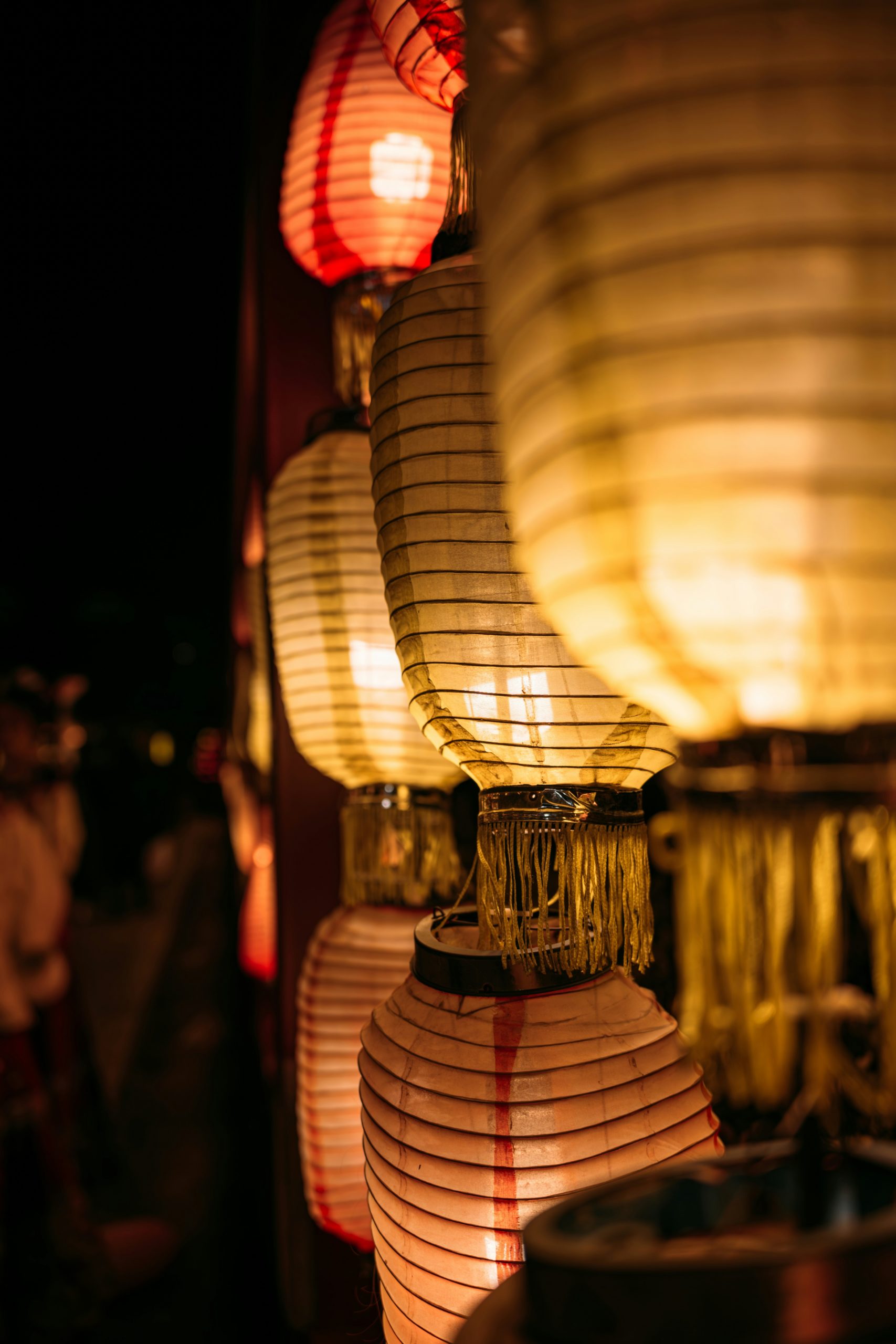 Beautiful illuminated paper lanterns glowing warmly in traditional Japanese festival setting, perfect for summer kimono photography in Gion district