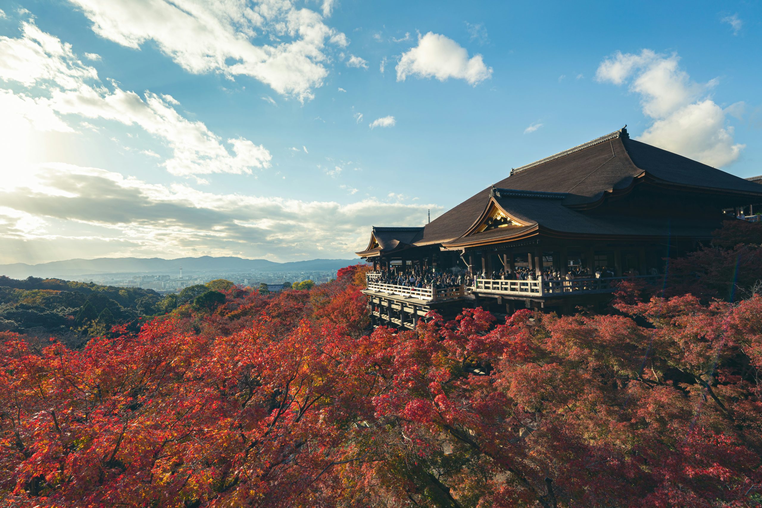 Iconic Kiyomizudera Temple in Kyoto with traditional wooden architecture and scenic mountain backdrop, UNESCO World Heritage site popular for kimono rental photography and cultural experiences