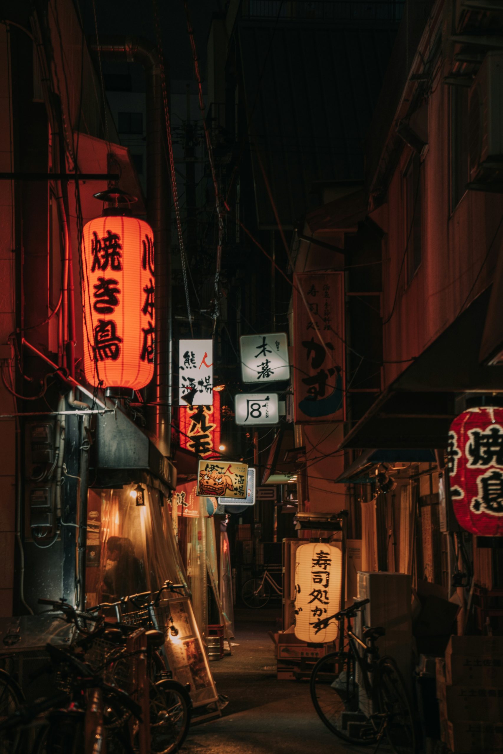 Yasaka Shrine in Kyoto illuminated at night with traditional paper lanterns creating atmospheric lighting for evening festivals
