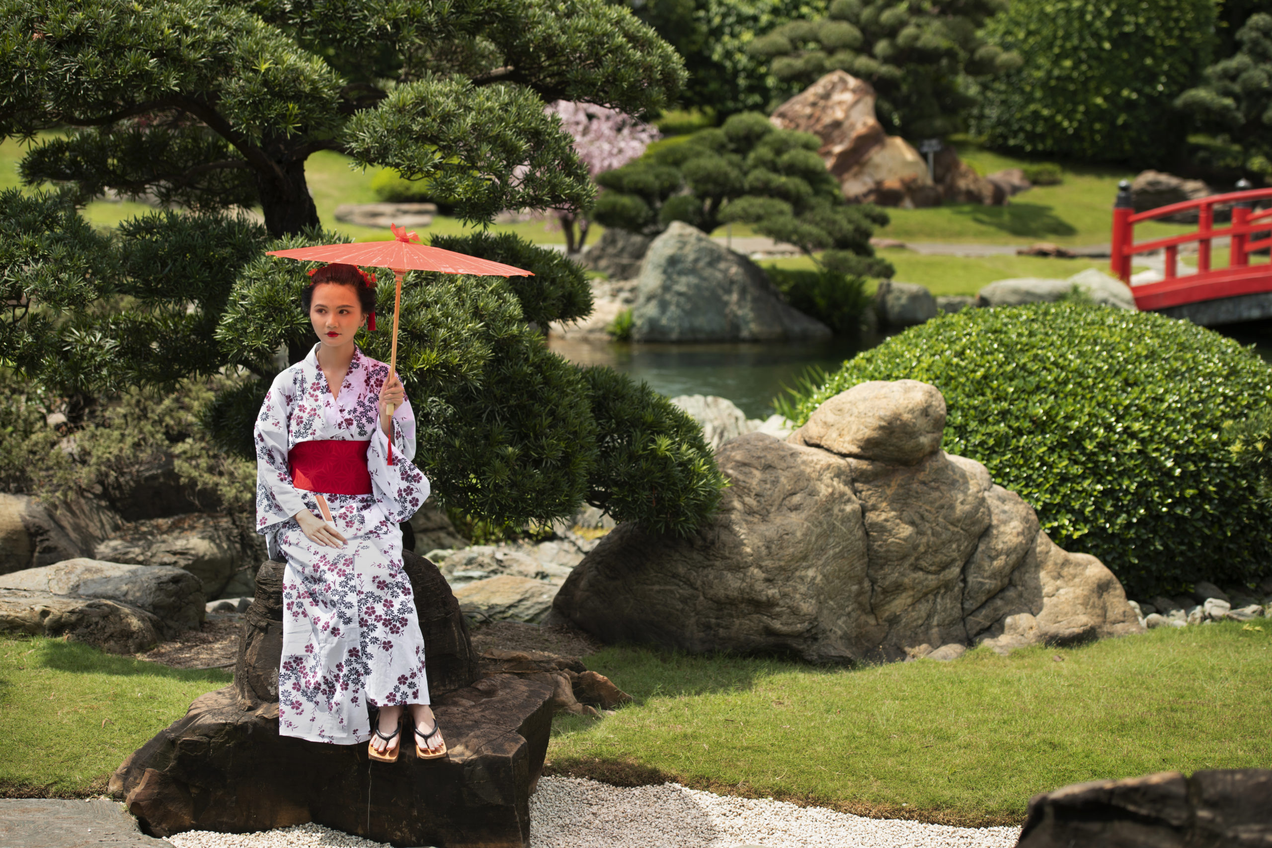 Beautiful winter scene in Kyoto with a woman wearing traditional kimono walking through snow-covered temple grounds creating a serene and magical atmosphere
