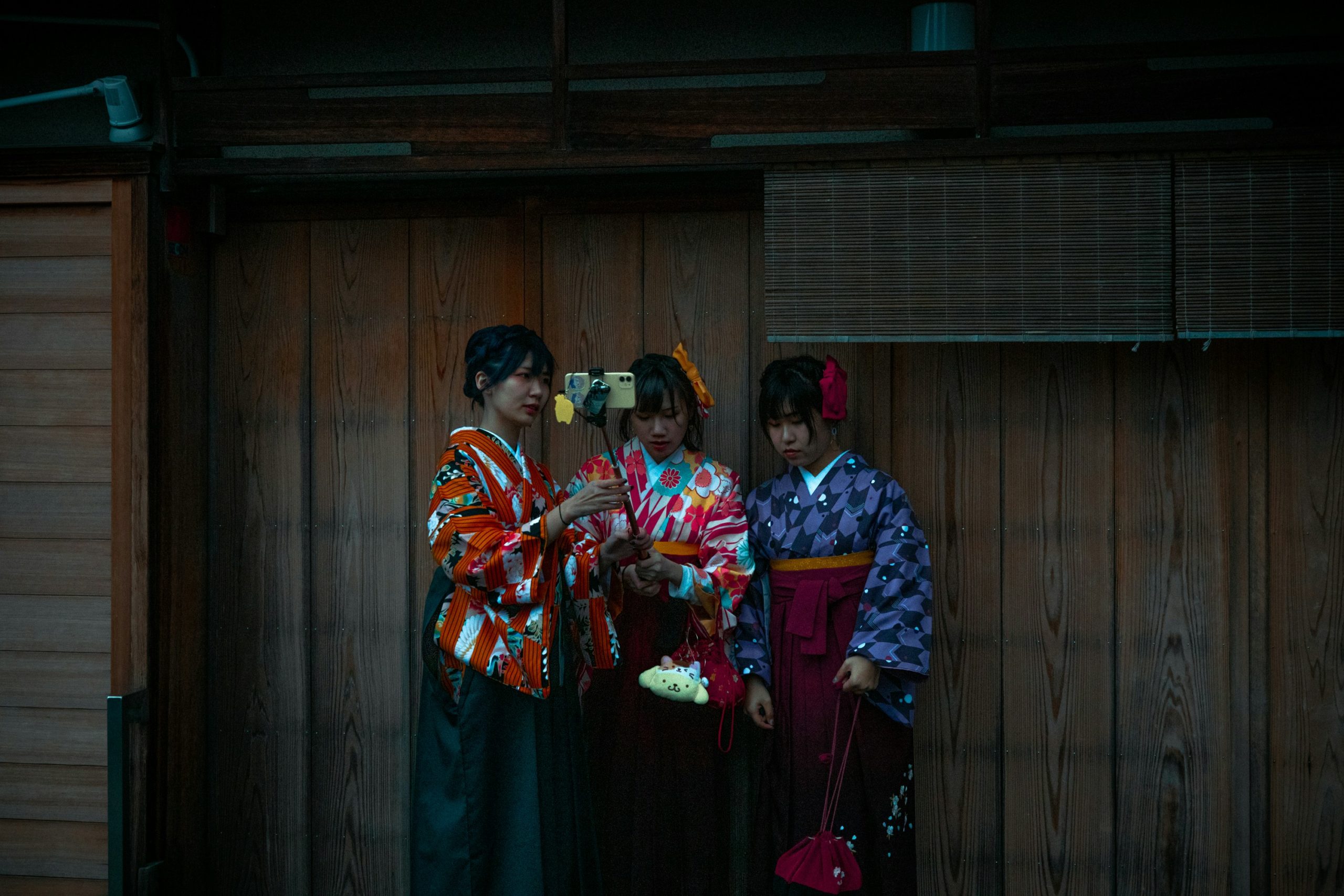 Japanese couple in traditional kimono and yukata climbing stairs to visit Kiyomizu-dera temple during autumn season in Kyoto, showcasing romantic cultural experiences
