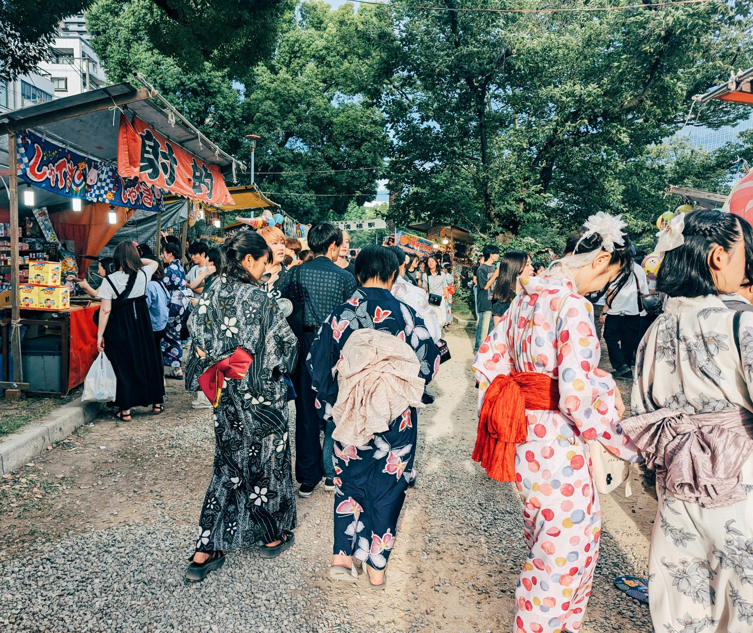 Participants in colorful traditional kimono and yukata celebrating Gion Matsuri festival in Kyoto, demonstrating the role of traditional clothing in Japanese Shinto festivals